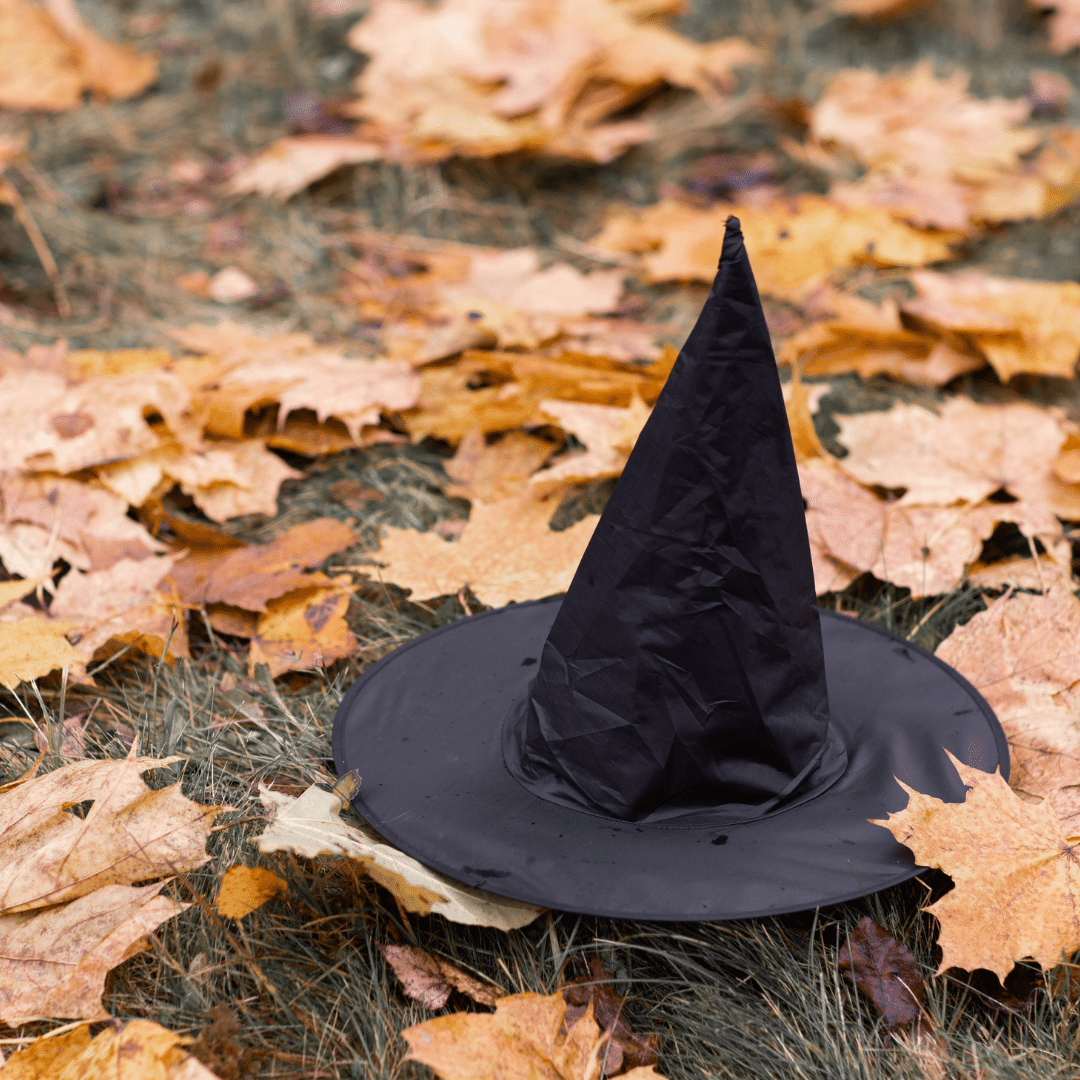 Halloween witch hat on ground surrounded by leaves, for Halloween events in Wilmington Delaware